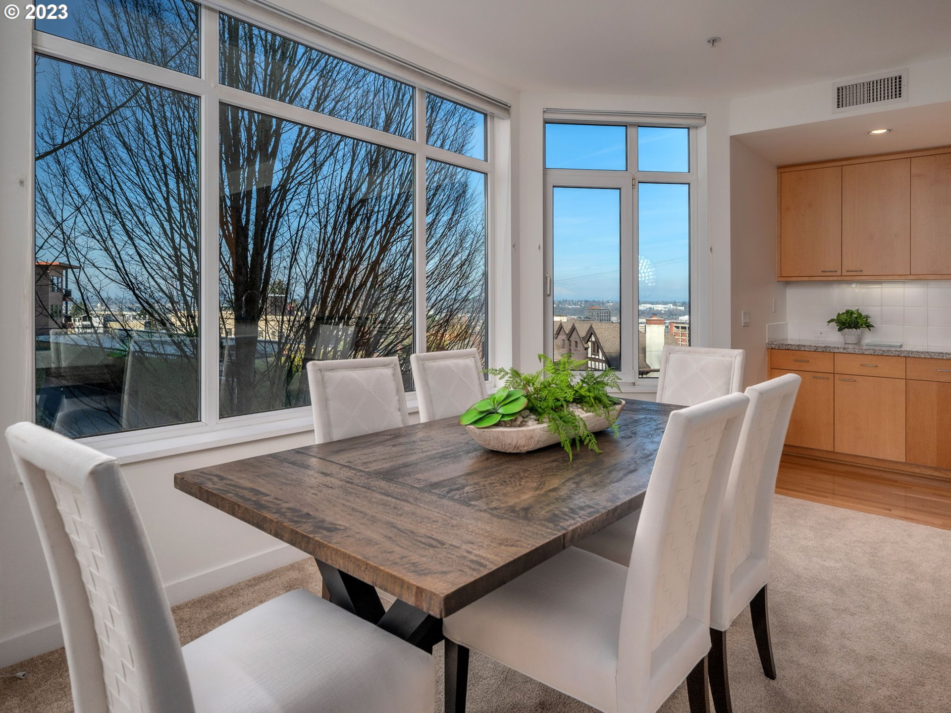 2445 Northwest Westover Road, Unit 314 Portland, OR 97210 - Photo 6 of 32 a view of a dining room with furniture window and wooden floor