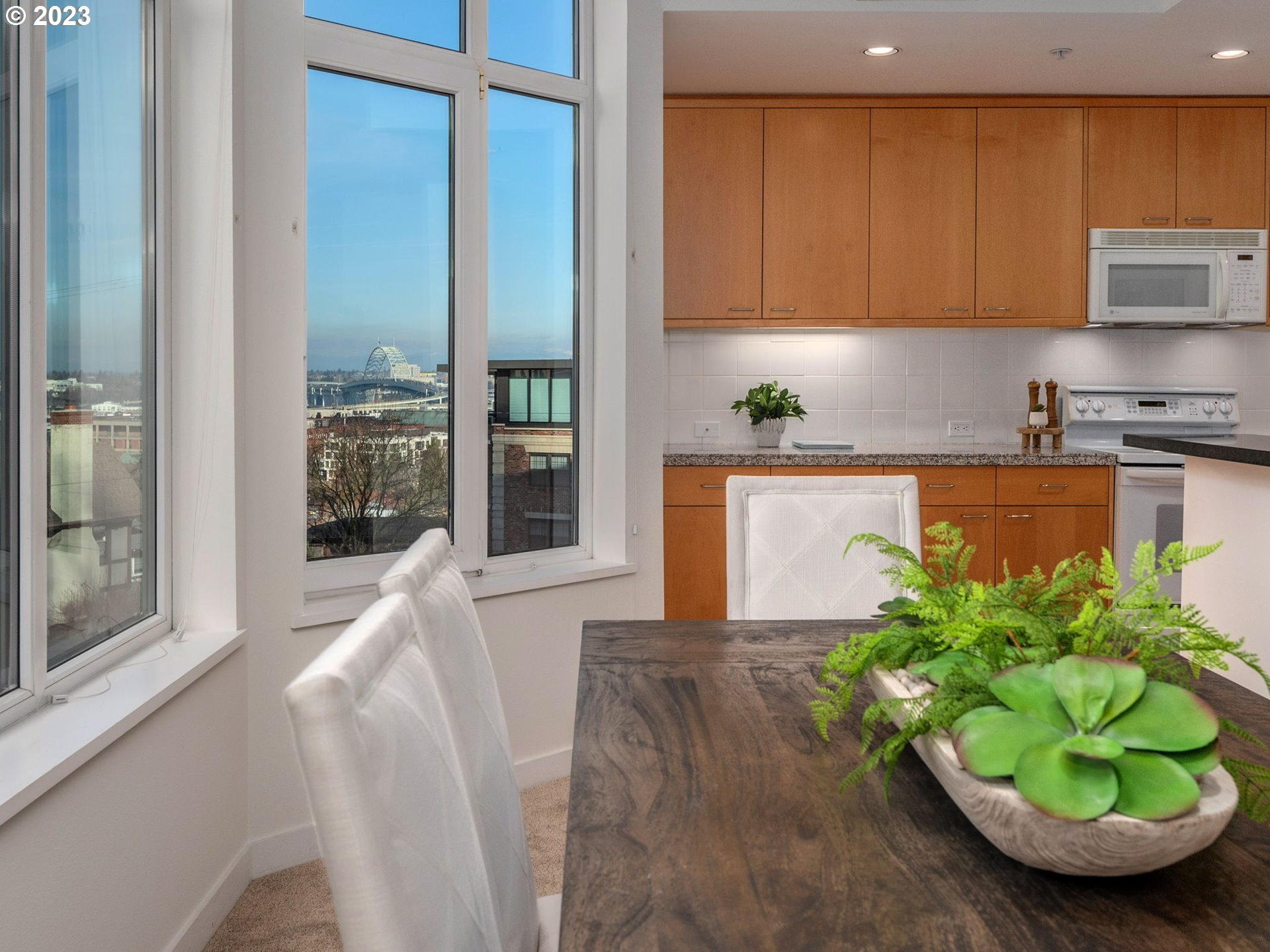 2445 Northwest Westover Road, Unit 314 Portland, OR 97210 - Photo 7 of 32 a room with stainless steel appliances a potted plant and a window