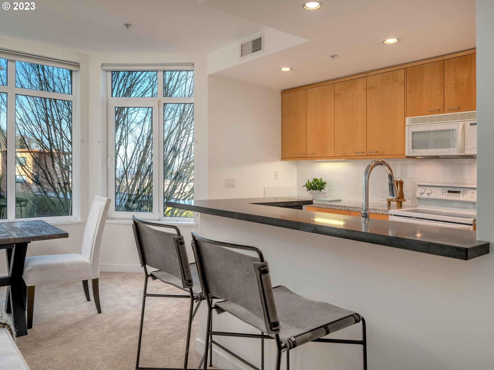 2445 Northwest Westover Road, Unit 314 Portland, OR 97210 - Photo 8 of 32 a kitchen with a sink chairs and cabinets