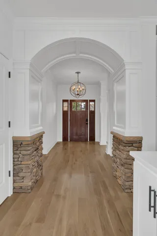 a view of an empty room with cabinet and a window
