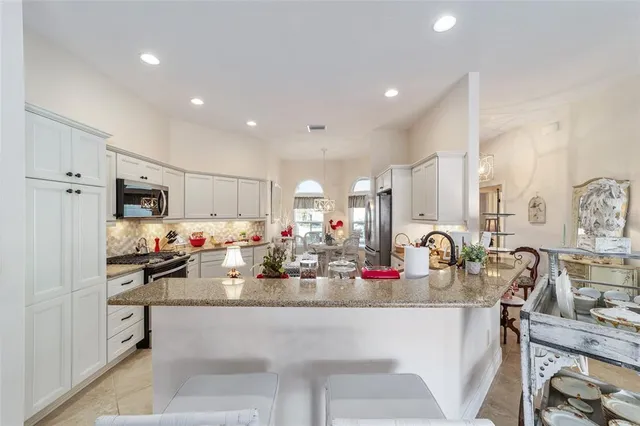 a kitchen with counter top space cabinets and appliances
