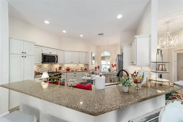 a kitchen with sink a counter and cabinets
