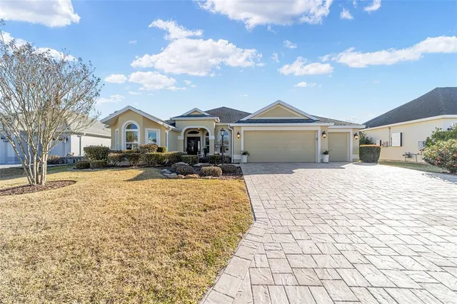 a front view of a house with a yard covered in snow