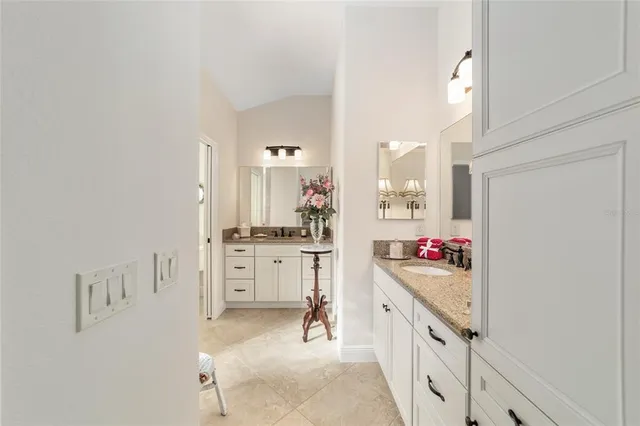 a kitchen with white cabinets and appliances