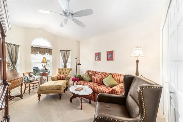 a living room with furniture ceiling fan and a rug
