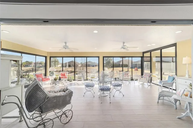 a living room with furniture and large windows
