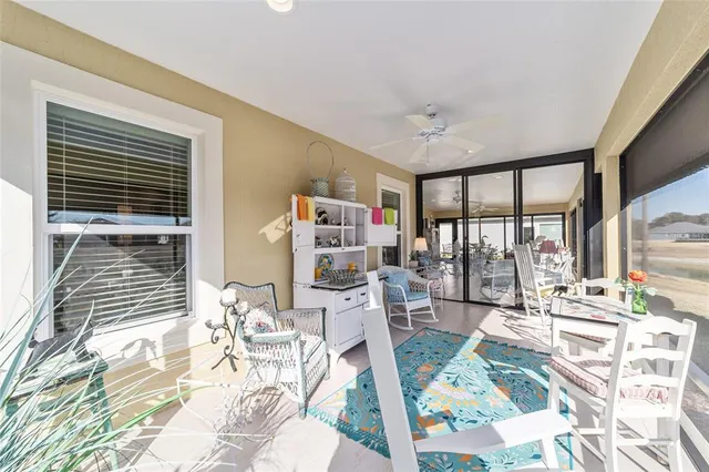 a view of a porch with a table and chairs and potted plants