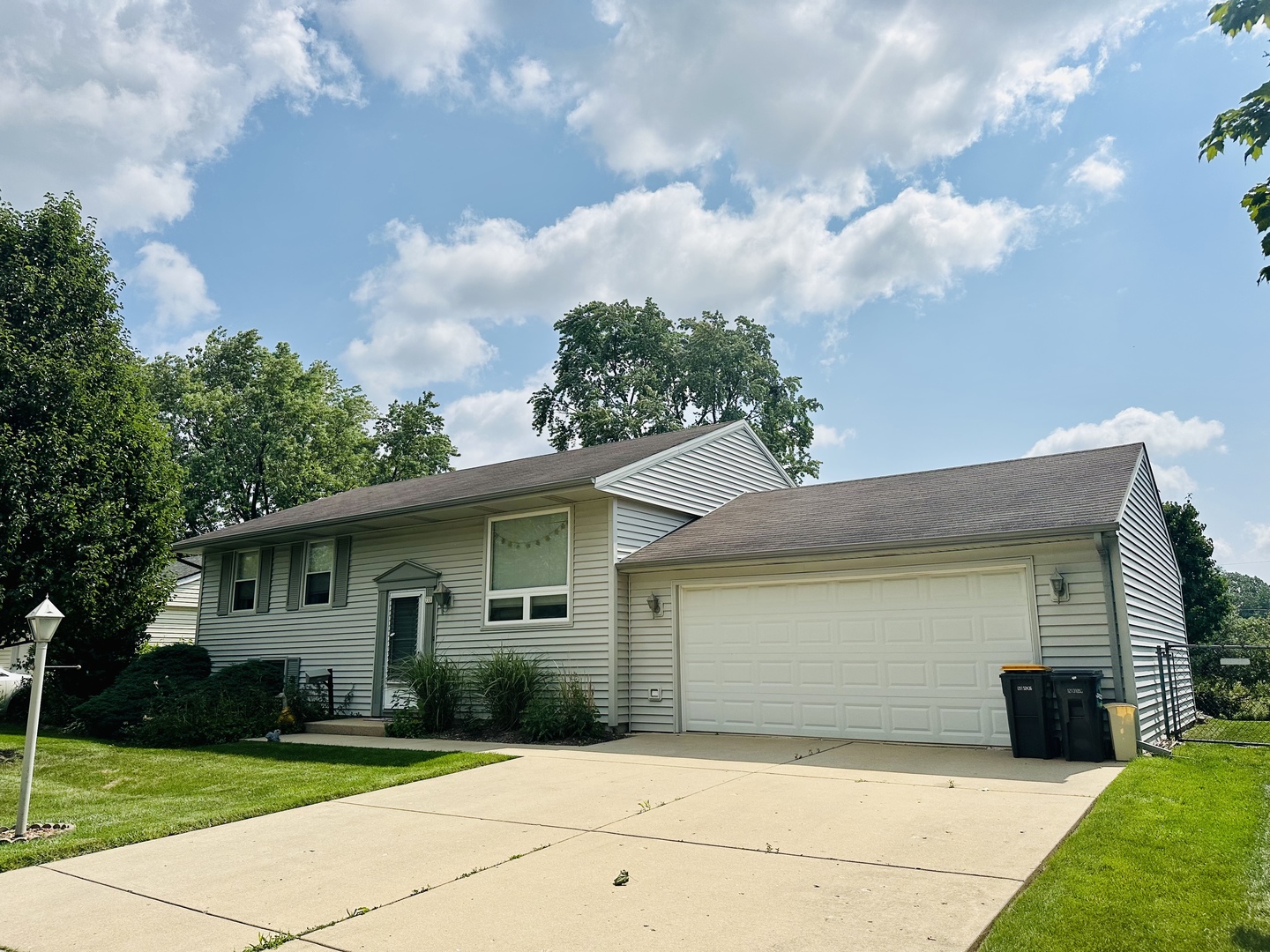 701 Parkside Circle Streamwood, IL 60107 - Photo 1 of 13 a front view of a house with garden