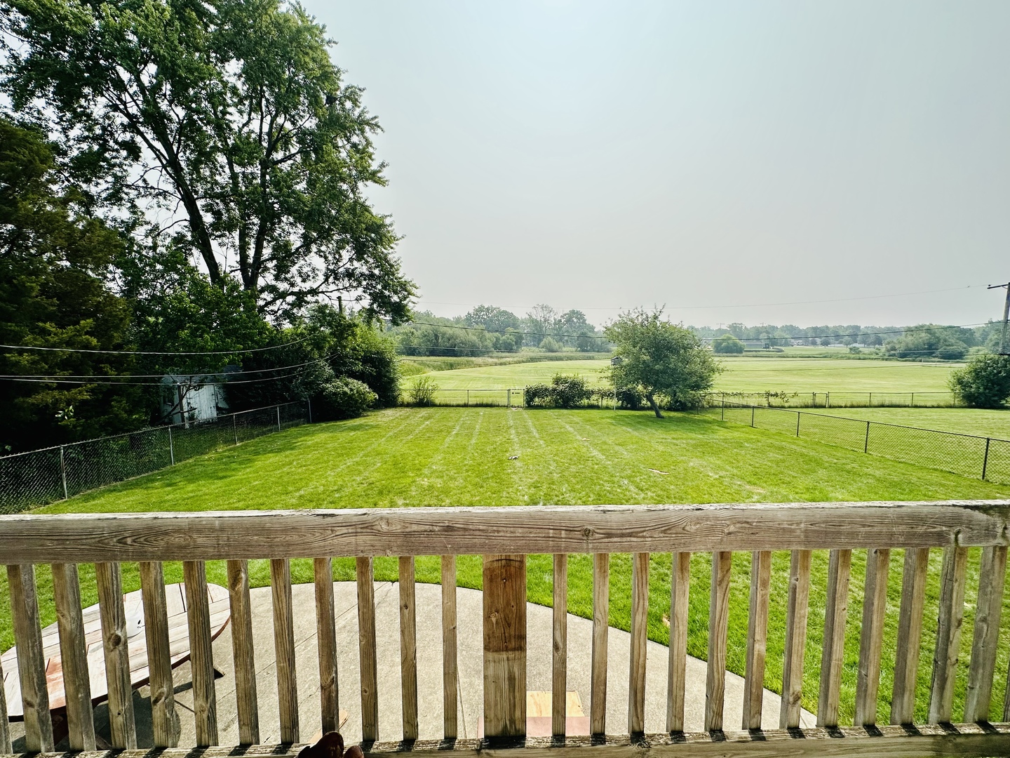 701 Parkside Circle Streamwood, IL 60107 - Photo 11 of 13 a view of green field with wooden fence