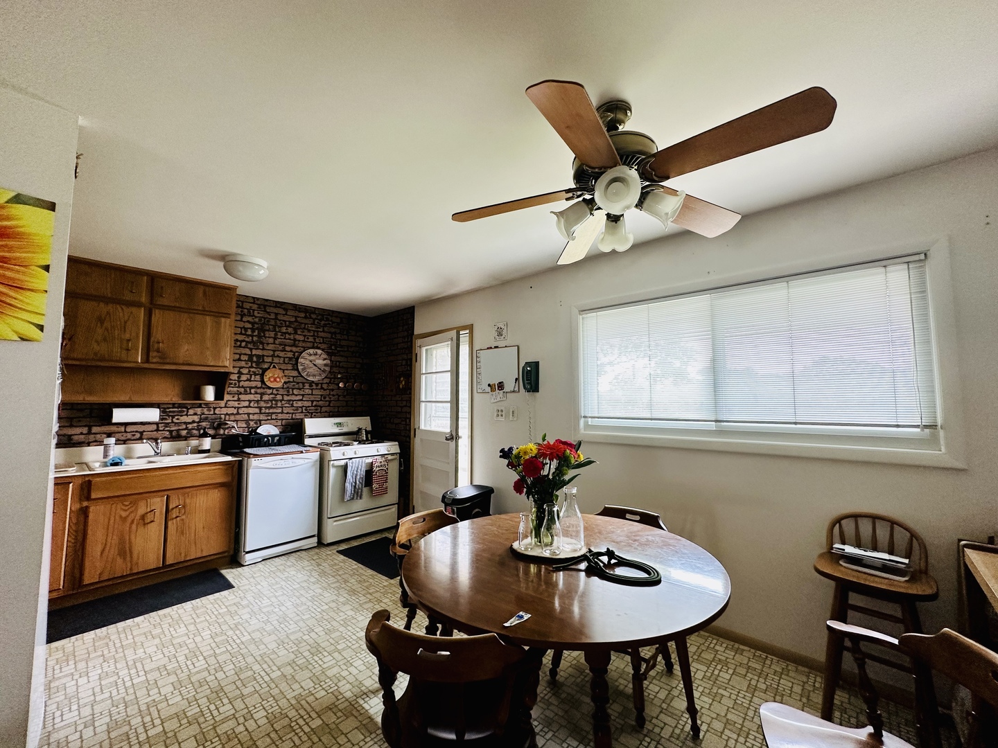 701 Parkside Circle Streamwood, IL 60107 - Photo 4 of 13 a kitchen with stainless steel appliances kitchen island granite countertop a stove a sink dishwasher a dining table and chairs with wooden floor