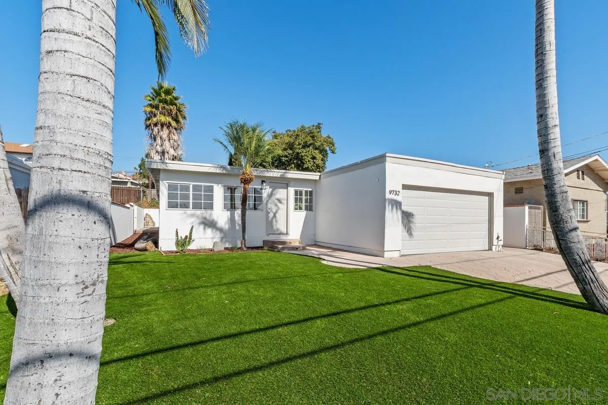 9732 St George Street Spring Valley, CA 91977 - Photo 1 of 26 a front view of a house with a yard and garage
