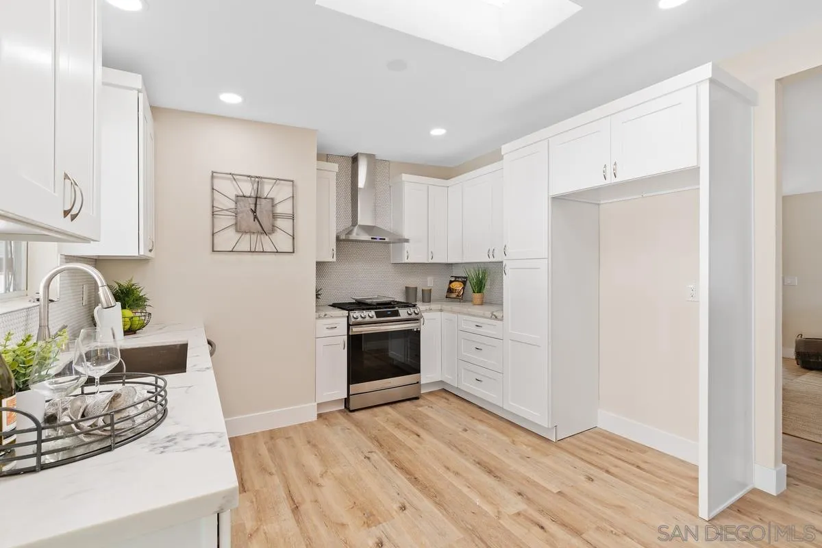 9732 St George Street Spring Valley, CA 91977 - Photo 11 of 26 a kitchen with a refrigerator and a stove top oven