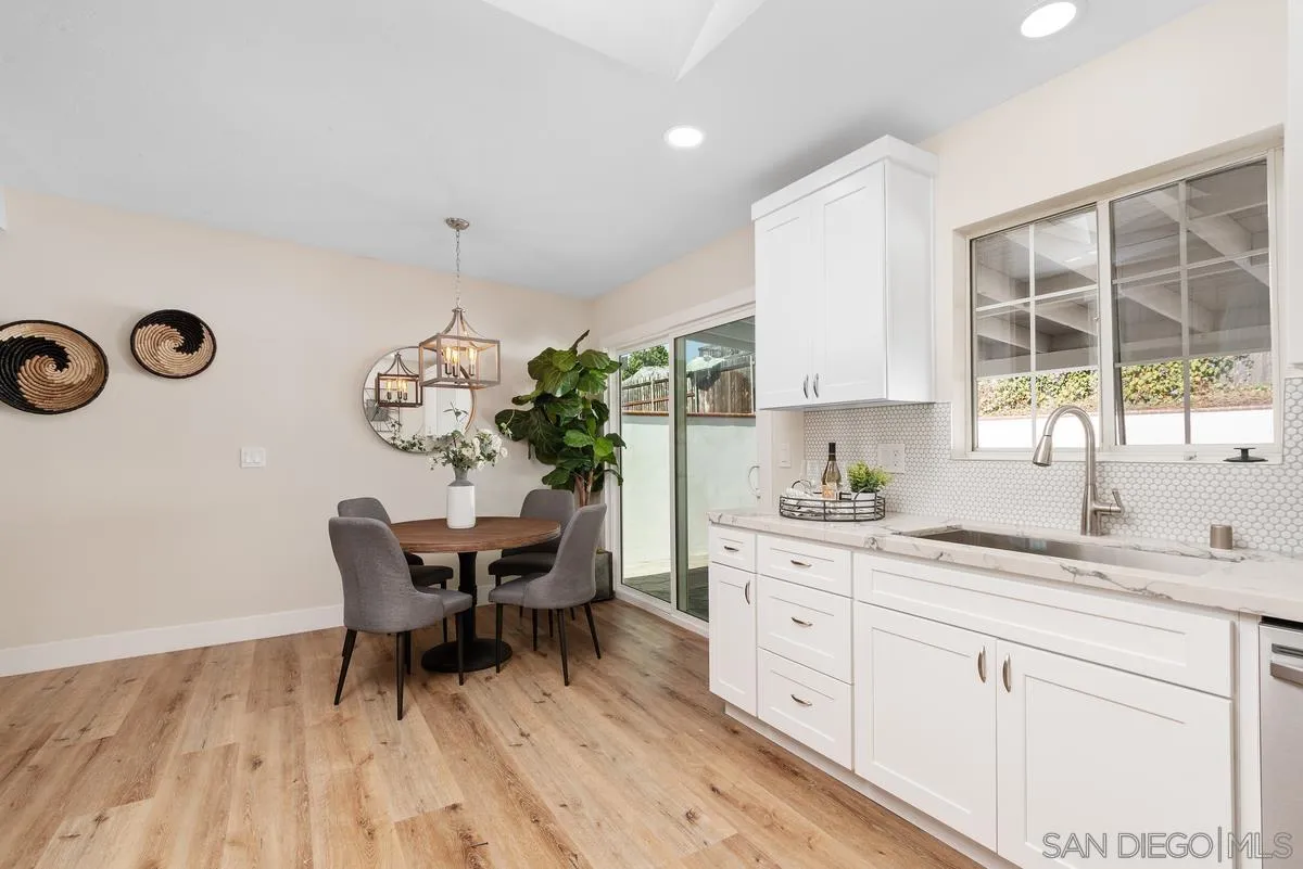 9732 St George Street Spring Valley, CA 91977 - Photo 12 of 26 a kitchen with granite countertop white cabinets and white appliances