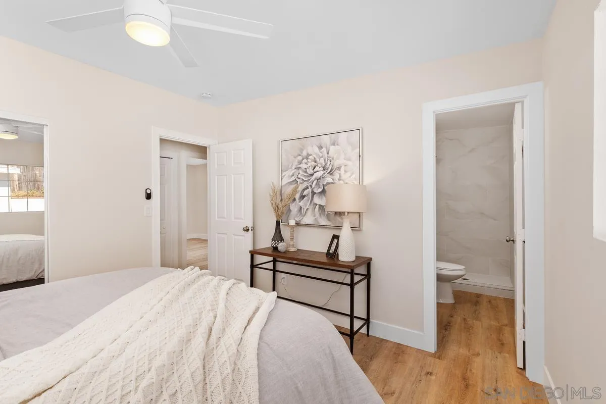 9732 St George Street Spring Valley, CA 91977 - Photo 14 of 26 a bedroom with a bed and a chandelier
