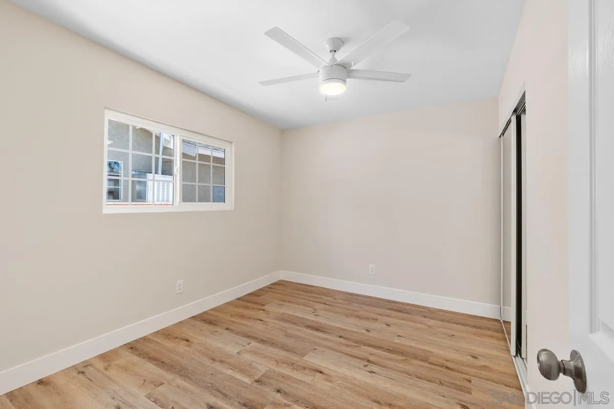 9732 St George Street Spring Valley, CA 91977 - Photo 16 of 26 a view of an empty room with wooden floor and a window