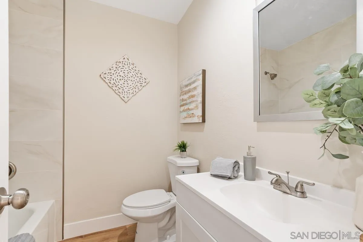 9732 St George Street Spring Valley, CA 91977 - Photo 18 of 26 a bathroom with a sink mirror and toilet