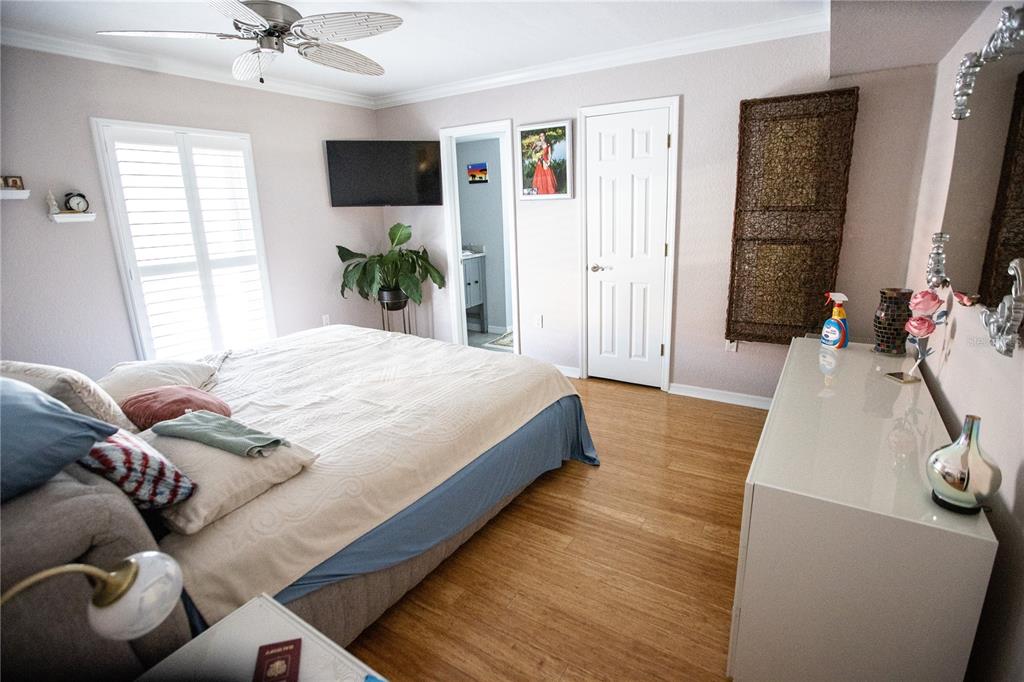 8911 Blind Pass Road, Unit 220 St. Pete Beach, FL 33706 - Photo 25 of 67 a bedroom with a bed window and a flat screen tv