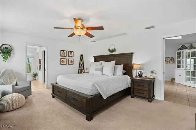 a bedroom with a bed and ceiling fan