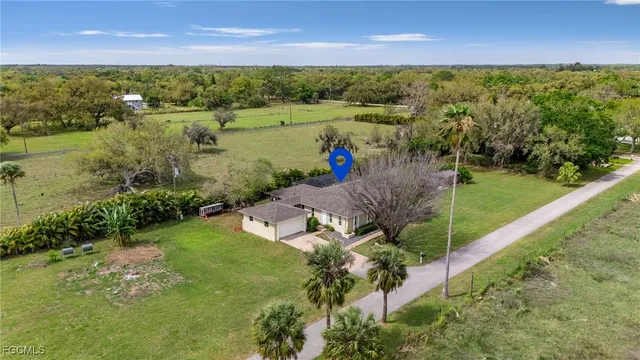 an aerial view of a houses with a yard