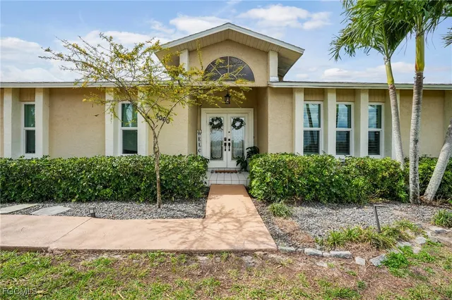a view of a brick house with a clock on the walls