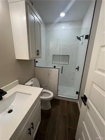 a bathroom with a sink a toilet and a mirror
