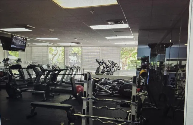 a living room with furniture and gym equipment