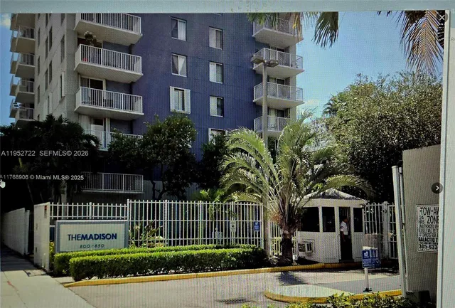 a view of a swimming pool with sitting area and furniture