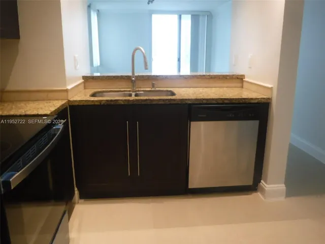 a kitchen with a sink and a microwave