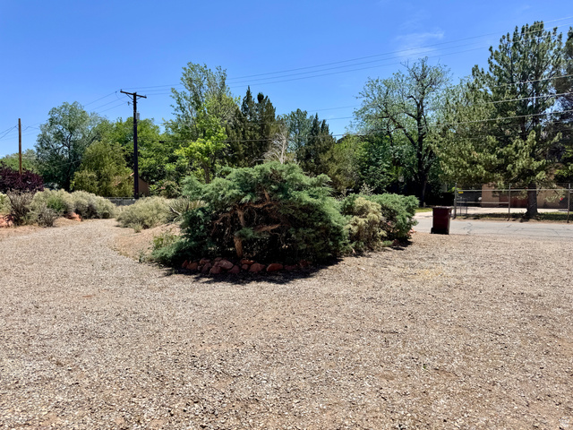 178 Walnut Lane Moab, UT 84532 - Photo 23 of 25 Gravel lot featuring established shrubbery and mature trees
