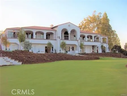 a view of a big yard with an ocean view