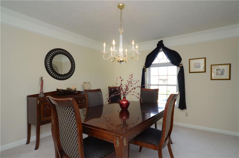 4 Wellington Court McKees Rocks, PA 15136 - Photo 5 of 24 FORMAL DINING ROOM WITH NEUTRAL DECOR, CARPET AND CROWN MOLDINGS