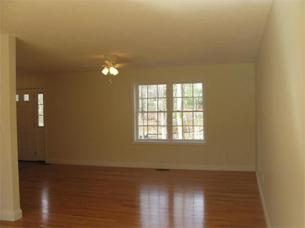 162 Leslie Road Rowley, MA 01969 - Photo 8 of 17 a view of an empty room with wooden floor and a window