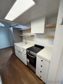 a utility room with cabinets washer and dryer