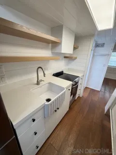a kitchen with cabinets and wooden floor