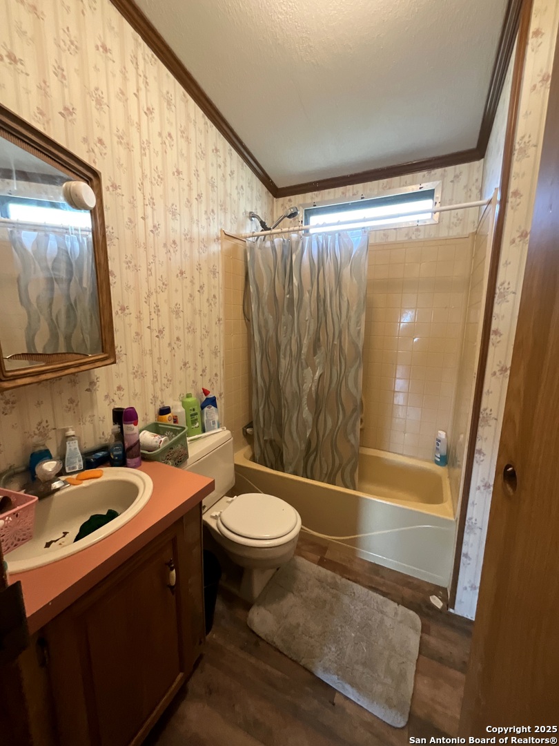 1 3rd Street Pettus, TX 78146 - Photo 12 of 16 a bathroom with a sink and mirror with toilet