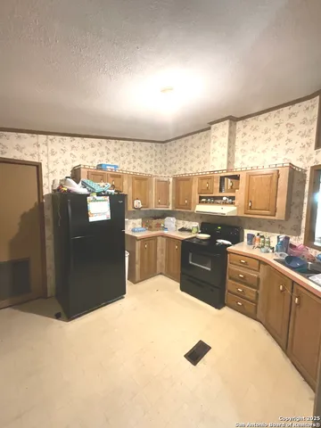 a kitchen with stainless steel appliances granite countertop a refrigerator and a stove