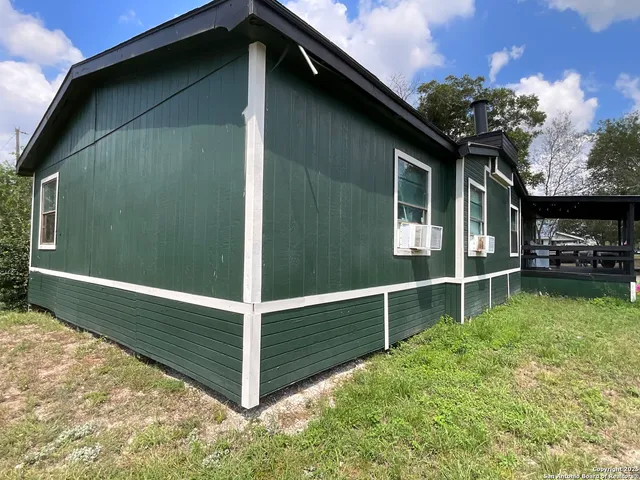 a view of backyard with cabin