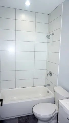 a bathroom with a toilet and bathtub