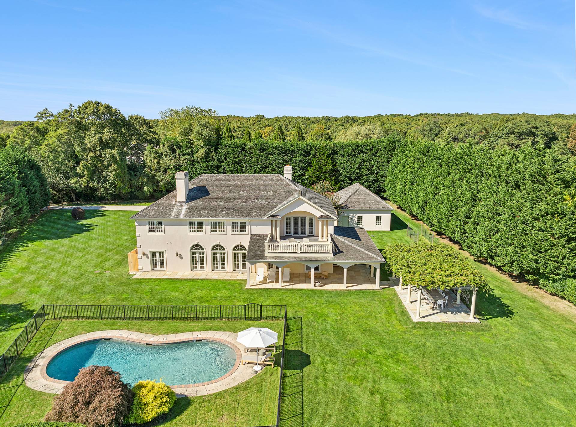 a aerial view of a house with a big yard and large trees