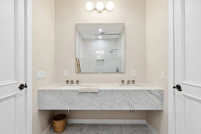 a bathroom with a double vanity sink and a mirror