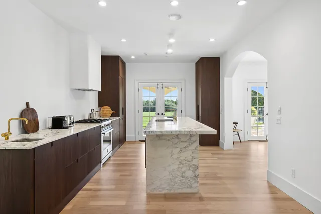 a large kitchen with stainless steel appliances kitchen island granite countertop a large counter top and sink