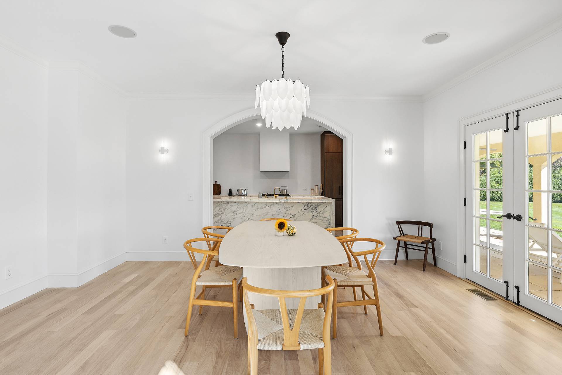 17 Jordan Drive Water Mill, NY 11976 - Photo 8 of 25 a dining room with wooden floor a chandelier a wooden table and chairs