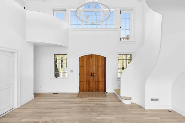 a view of an entryway with wooden floor