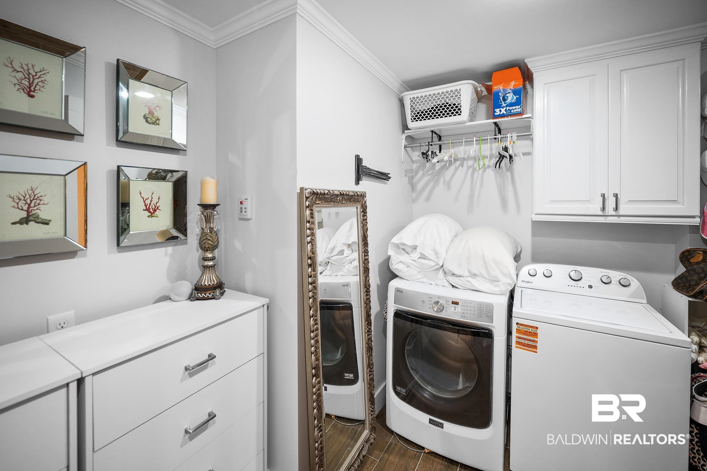 8490 Bay View Drive Foley, AL 36535 - Photo 42 of 67 Laundry area with cabinet space, ornamental molding, washing machine and clothes dryer, and dark wood-style floors