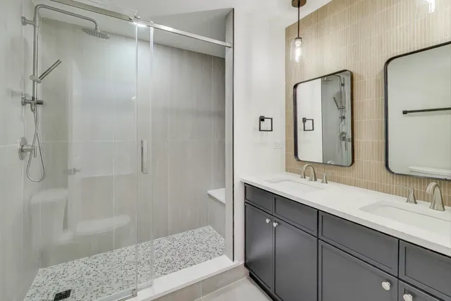 a bathroom with a shower sink and mirror