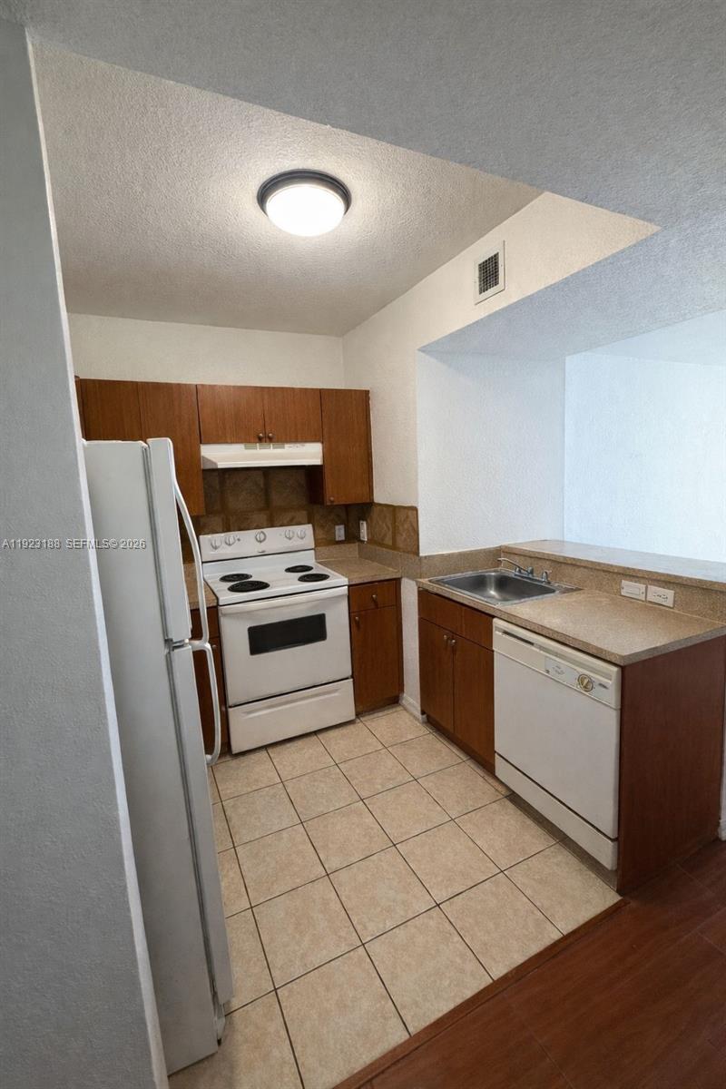 a kitchen with a stove sink and a microwave