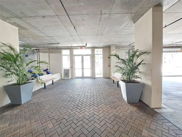 a view of living room filled with furniture and potted plant
