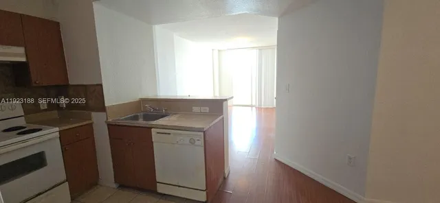 a kitchen with a stove microwave and sink