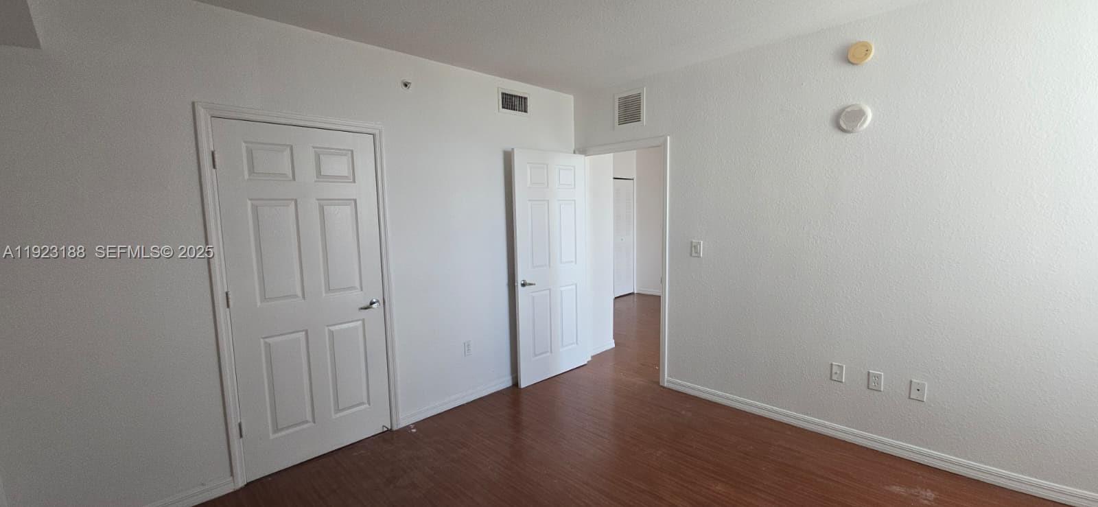 120 Southwest 8th Avenue, Unit 802 Miami, FL 33130 - Photo 27 of 31 a view of an empty room with wooden floor