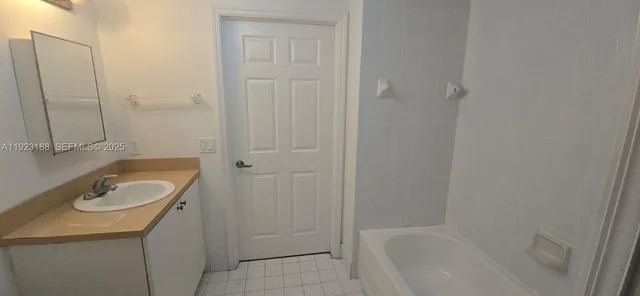 a bath room with a sink and a tub